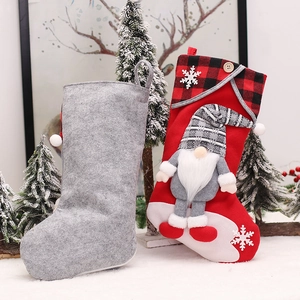 Pair of festive Christmas stockings featuring 3D gnome dolls and white snowflake patterns