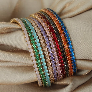 Colorful zircon tennis bracelet in 18K gold plated steel on champagne satin background