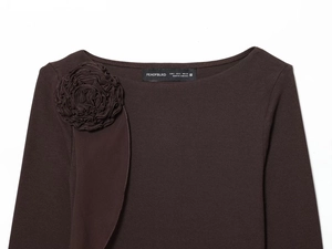 Detail of dark brown long sleeve top with 3D floral embellishments on the shoulder