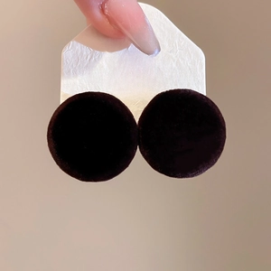 Detailed close-up of dark brown velvet circular stud earrings with S925 silver needles