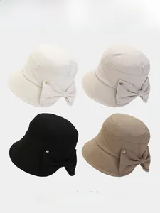 Detail view of foldable sun hats in cream, grey, black, and khaki with bow accents
