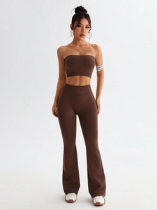 Detail of coffee brown two-piece yoga set with high waist flared leggings and sports crop top