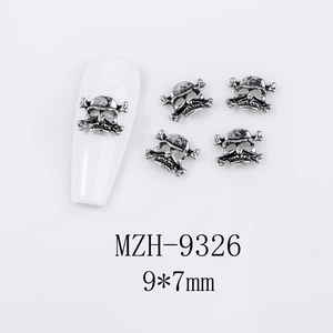 Detailed view of silver skull nail charms measuring 9x7mm on white background