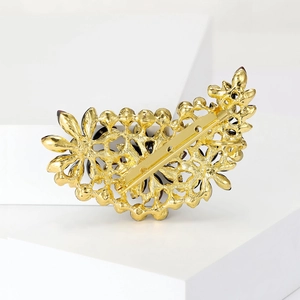 Detailed back view of vintage gold alloy brooch featuring an ornate hollowed-out pattern