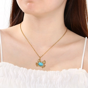 18K gold plated stainless steel necklace with blue stone crab pendant on model