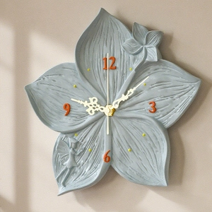 Detail of flower lotus wall clock mold with fairy relief and golden vintage hands
