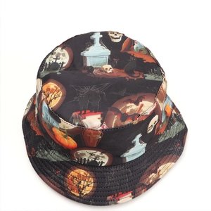 Detailed view of Halloween bucket hat with skull, pumpkin, and tombstone pattern print