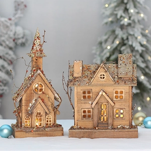 Lighted wooden Christmas cabin ornaments with gold glitter roofs and warm LED glow