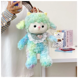 Detail of curly plush sheep doll bag with embroidered scarf held in a lifestyle setting