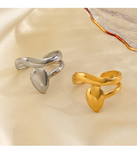 Detailed close-up of teardrop open rings in gold and silver finish on silk fabric