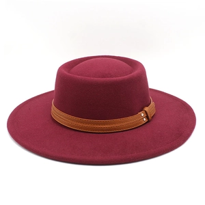 Detailed view of burgundy flat top wool hat with brown leather belt and silver buckle