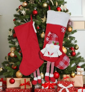 Detail of plush Christmas stockings with gnome figures and snowflake accents
