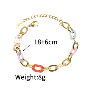 Detail of colorful resin and gold steel chain bracelet with lobster clasp and tag