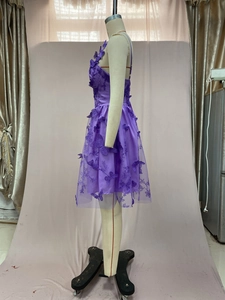 Detail of purple tulle party dress featuring romantic 3D butterfly floral appliques