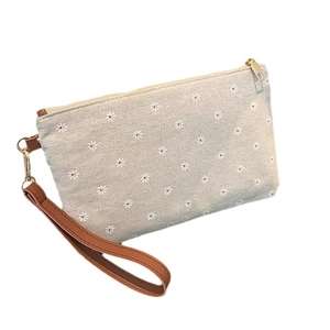 Minimalist beige daisy floral straw clutch bag with brown PU strap and gold zipper