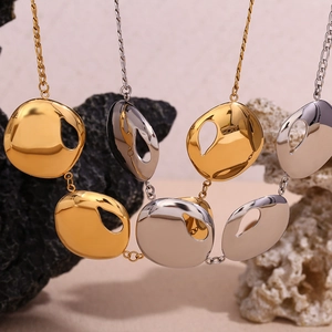 18K gold and silver teardrop cutout round pendants on stainless steel necklaces