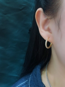 Close-up of gold-plated sterling silver hoop earrings with sparkling cubic zirconia pavé
