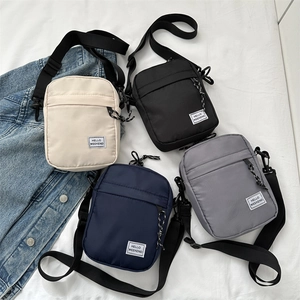Lightweight canvas crossbody bags for men and women in beige, black, navy, and grey