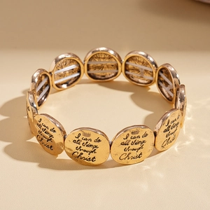Détail d'un bracelet religieux doré avec texte I can do all things through Christ gravé