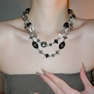 Close-up of double-layer beaded necklace featuring vintage wood beads and crystal details