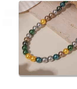 Detailed view of colorful 8mm pearl beads necklace arranged on a stone surface