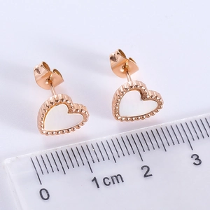 Minimalist rose gold heart stud earrings with white inlay and beaded edge detail
