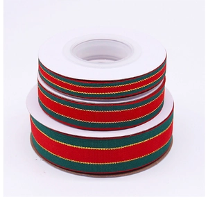 Macro view of Christmas ribbons with green red stripes and gold edges for gift wrapping