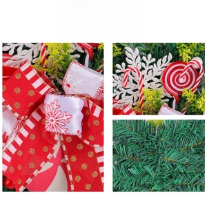 Detail of Christmas teardrop wreath with candy canes, large bow and glitter snowflakes