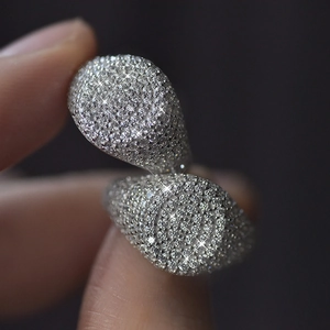 Macro shot of silver ring featuring micro-pave set diamonds with high sparkling finish