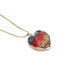 Colorful heart-shaped crystal pendant necklace with golden chain and mixed resin textures