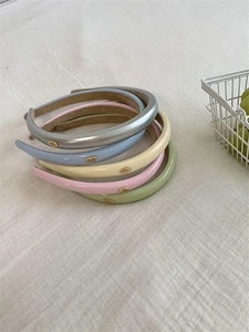 Detail view of colorful PU leather headbands in silver, blue, beige, pink and green