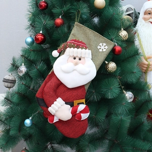 Close-up of a 50cm linen Christmas stocking with Santa Claus hanging on a tree