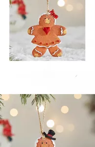 Detail of gingerbread man Christmas ornament with heart and bow details on a tree branch