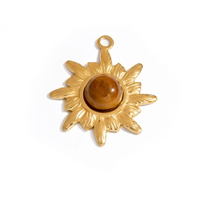 Macro detail of sunburst pendant with golden stainless steel and natural amber stone