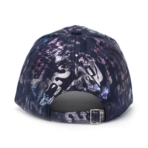 Detail of adjustable metal buckle and iridescent graffiti print on a navy baseball cap