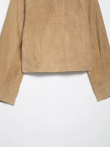 Close-up of the camel suede jacket showing back hem detail and double stitching