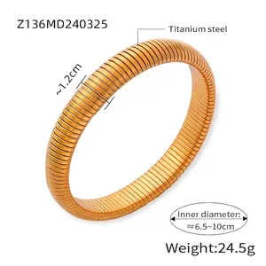 Close-up of flexible golden titanium steel bracelet showing ribbed texture and dimensions