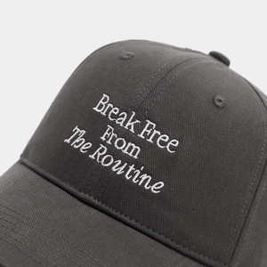 Detailed white embroidery text on a dark charcoal gray cotton baseball cap