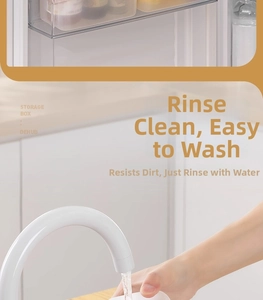 Close-up of a white plastic kitchen storage box being rinsed under a water faucet