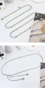 Detailed macro view of silver geometric chain belt with lobster clasp and metal bead