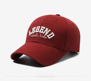 Close-up of burgundy baseball cap with white 3D embroidery and curved brim detail