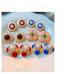Macro shot of French vintage enamel earrings with gold alloy and faux pearls
