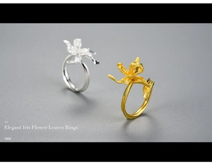 Detailed view of elegant iris flower rings in matte gold and silver brushed metal finish
