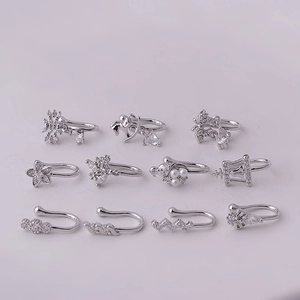 Set of 11 silver nose clips with micro-paved zircons and pearls on pink background