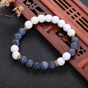 Vintage beaded bracelet with white lava stone, blue cracked beads and gold spacers