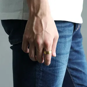 Close-up of a men's 8mm gold ring with a brushed matte center and polished edges
