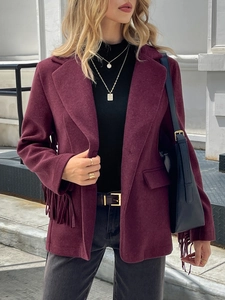 Detail of burgundy fringe trim on the cuffs and hem of a wool-blend jacket