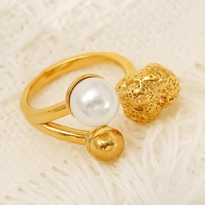Elegant gold open ring with a large white pearl and irregular textured metallic element