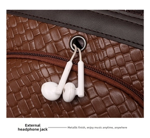 Detailed macro view of brown PU leather woven texture and external headphone jack port