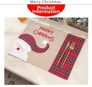 Close-up of linen Christmas placemat with Santa embroidery and red buffalo plaid trim